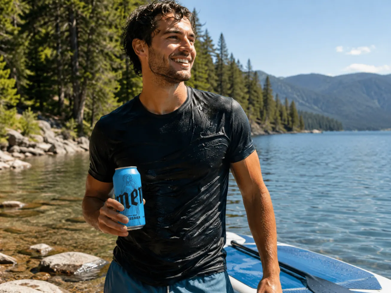 Man by an alpine lake holding an Amen Weissbier can